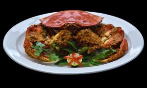 Alt - Dungeness crab stir fried with curry leaves, red chilli paste, grated coconut, tamarind, and thyme